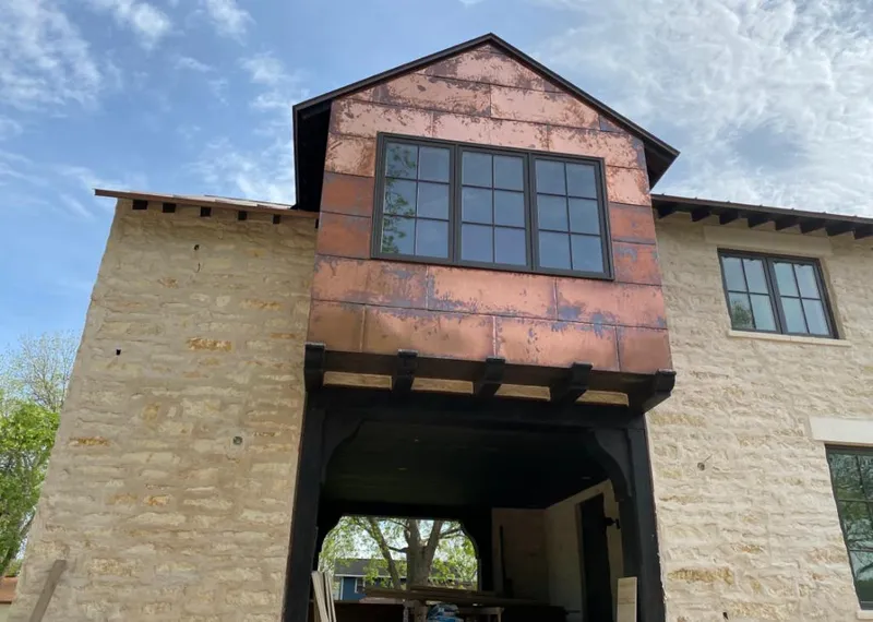 Copper metal panel facade on a stone building for Metal Roof Coating in Shakopee